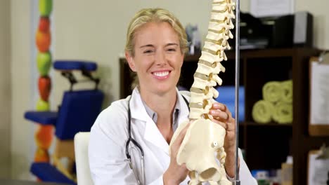 Physiotherapist-looking-at-spine-model