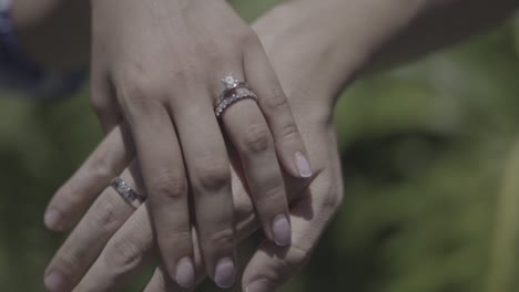 bride and groom hands with wedding rings