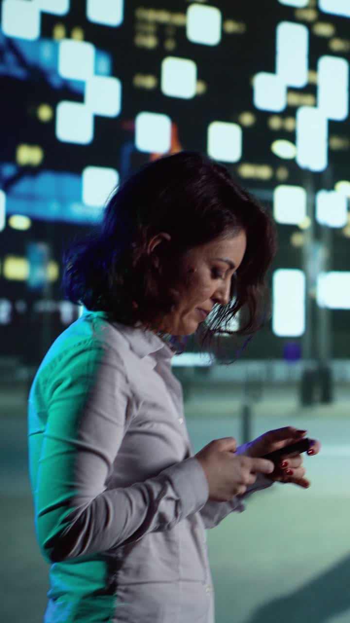 Vertical video Stylish person uses smartphone on walk