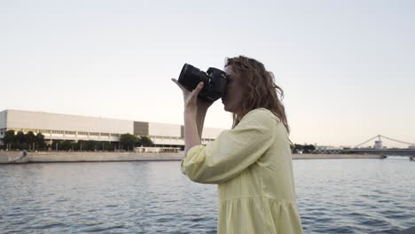 woman taking photo of a statue by the river in saint petersburg