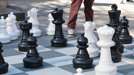 people playing giant chess in public space