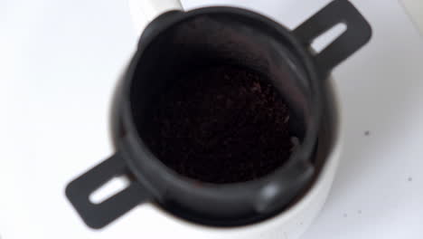 pouring hot water into pour-over filter with fresh ground coffee