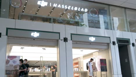 passersby stroll past the illuminated dji store in hong kong, where customers examine the latest drone technology from the well-known chinese brand.