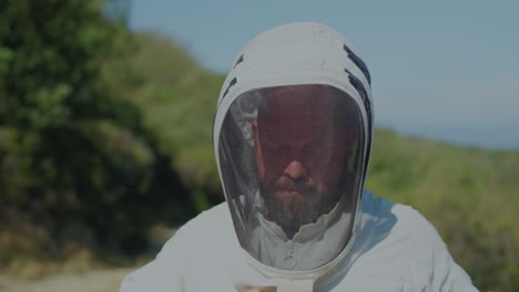 beekeeper adjusting protective suit outdoors