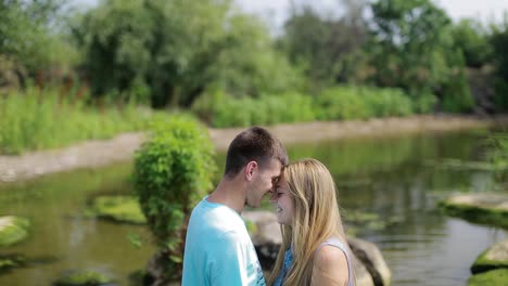 young couple resting on the river. guy and girl in the relationship enjoying near water