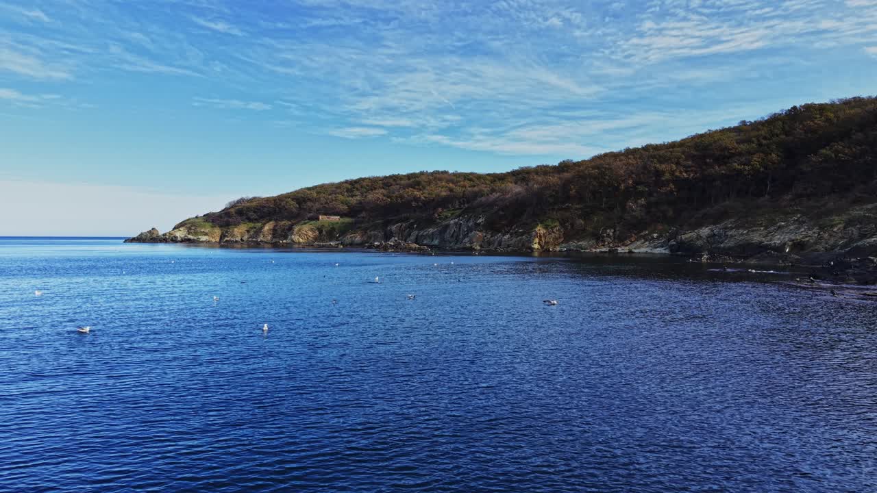Coastal view showcasing calm blue waters and serene landscape
