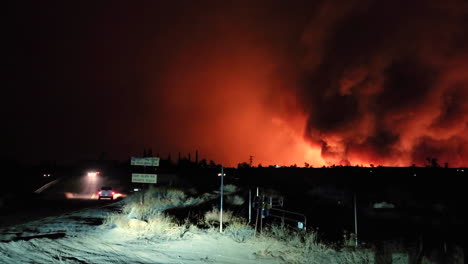 white pickup truck rushing towards massive wildfires of