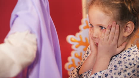 little girls scare each other. emotions of the child. studio shooting of children