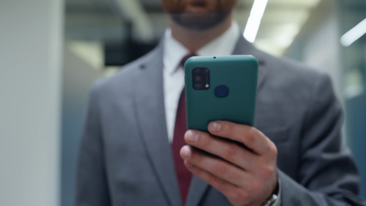 Boss hands holding smartphone strolling vestibule closeup. Bearded man messaging