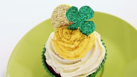 muffin with white and yellow cream tooping for  st patricks