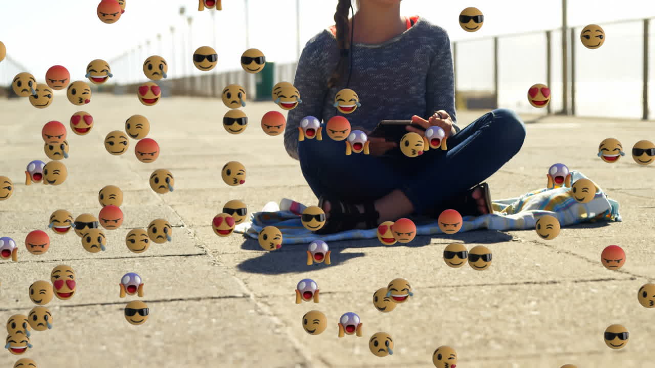 varios emojis de cara moviéndose contra una chica con auriculares escuchando música
