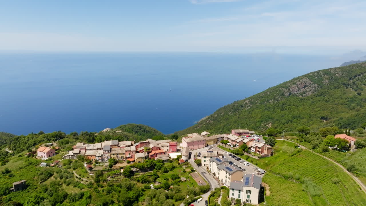 Aerial view rotating toward the Montaretto town, summer day in Liguria, Italy