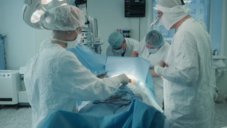 nurse gathers steel tools in surgery room. cardiological surgeons take care after coronary artery bypass surgery with in hospital. dangerous operation