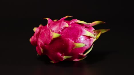 dragon fruit rotates smoothly on a dark surface