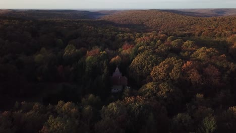 Amazing-autumn-colors-with-an-old-forest-cabin-abandoned-within-the-forest