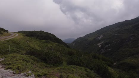 4K-drone-footage-captures-Swiss-Alps'-natural-beauty-as-the-sun-sets-through-clouds-at-Gotthard-Pass