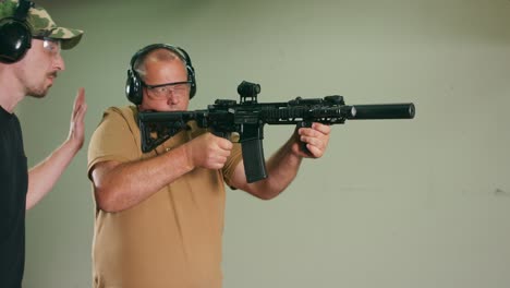 the stressed student fires the first shot from the rifle at the shooting range