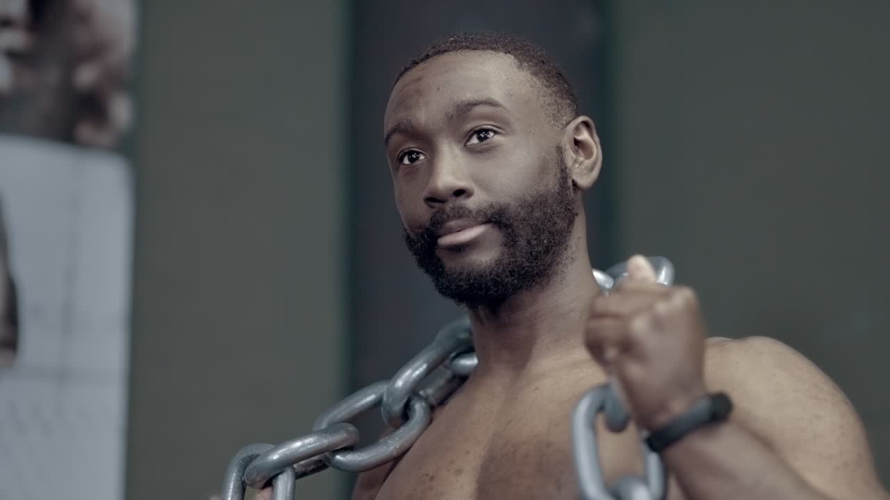 African American man adjusted weighted chain for dips exercise