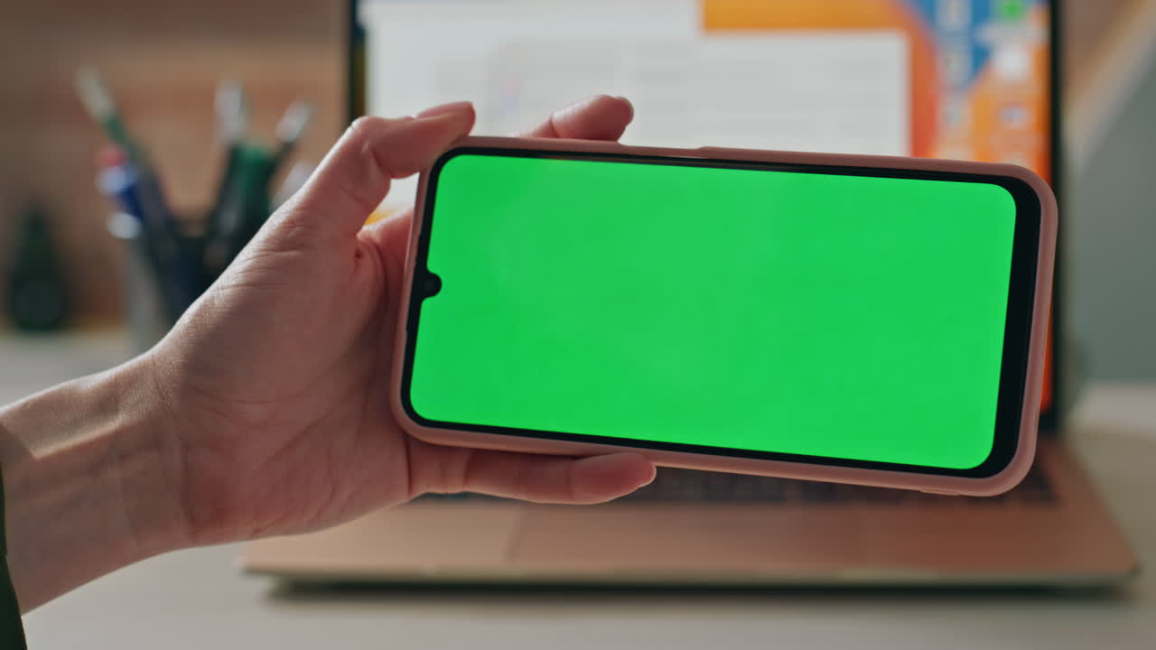 Unrecognizable employee watching green screen smartphone education video closeup