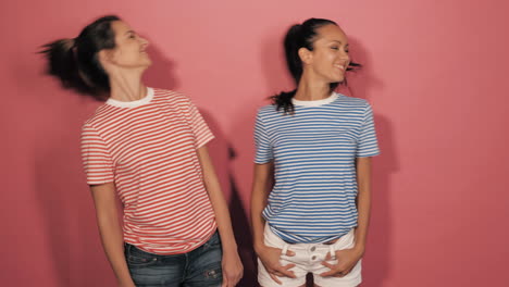 two women posing in striped shirts