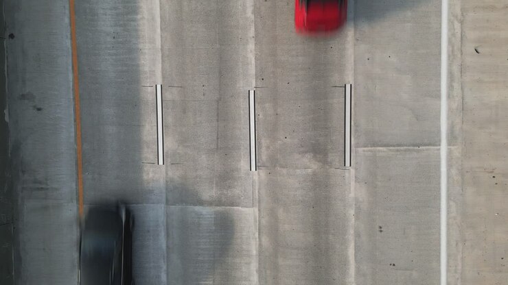Aerial POV Looking Straight Down of Cars Driving on 4 Lane Highway, Moving from Bottom to Top of Frame