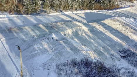 preparation of snow skiing track in resort on sunny winter day, fusion time lapse