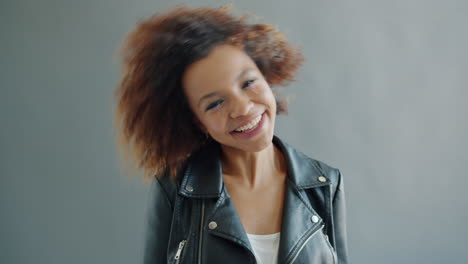 happy woman with curly hair and leather jacket