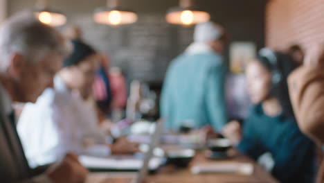 blurred cafe with customers in busy coffee shop bustling with activity background copy space intro 4k footage