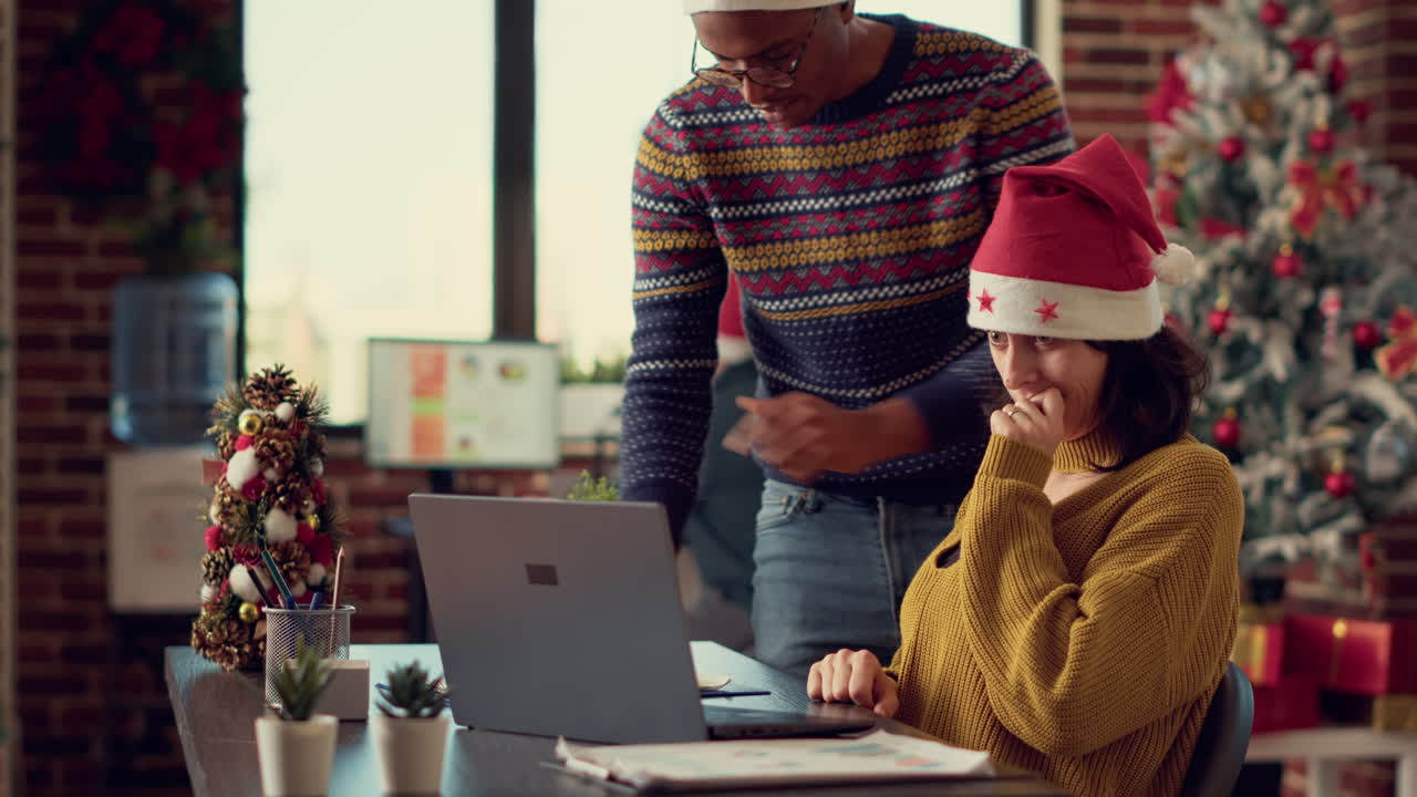 Diverse people analyzing information on laptop