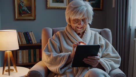 senior woman using tablet in living room