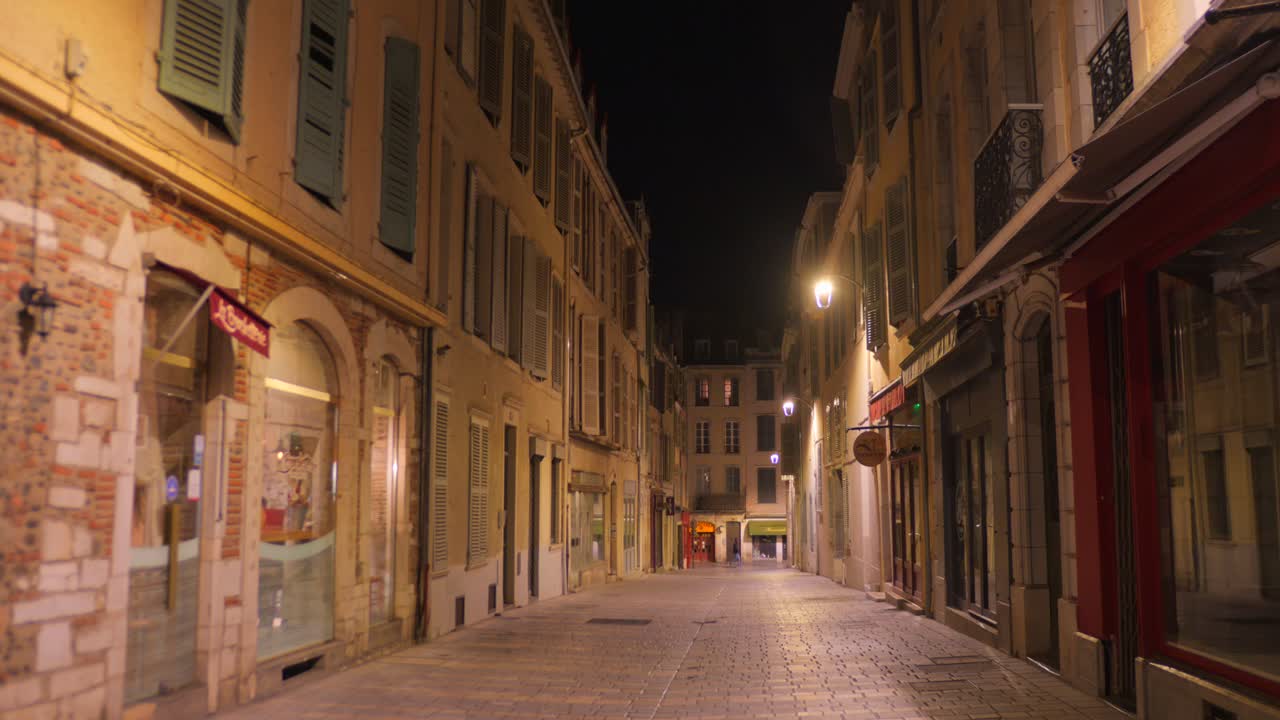 Old town street in Pau France with historic architecture and traditional European charm illuminated at night