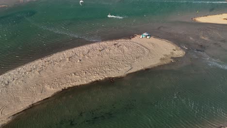 Kiteboarder-makes-giant-leaps-over-sandbars-in-lagoon,-Tatajuba,-Brazil