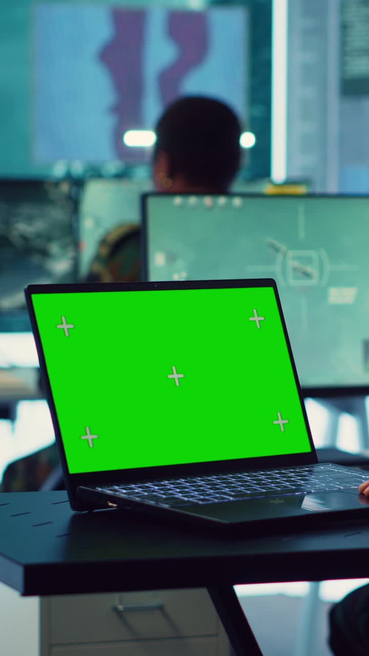 Laptop with Green Screen Display on Office Desk