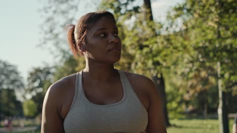 Focus-young-woman-doing-training-at-the-park-in-summer-day.