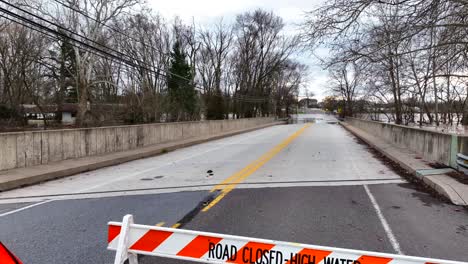 road closed - high water sign at bridge with flooding