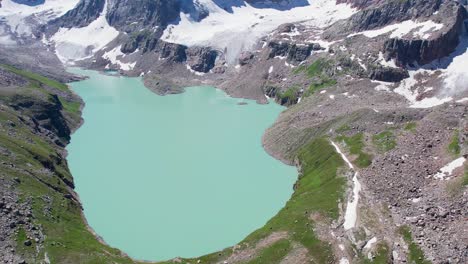 slow aerial drone shot of chitta katha lake in the himalayan mountain range