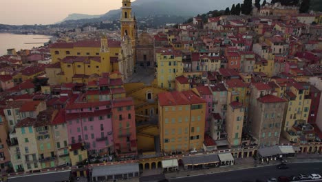 Seagull-Bird-Chasing-Drone-at-Sunset-in-Menton,-France---Aerial