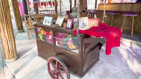 decorative cart with vibrant items and frames