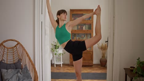 woman practicing yoga in a doorway