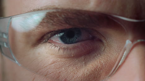 Macro-of-opened-male-blue-eye-wearing-glasses.-Beautiful-details-of-human-eye.