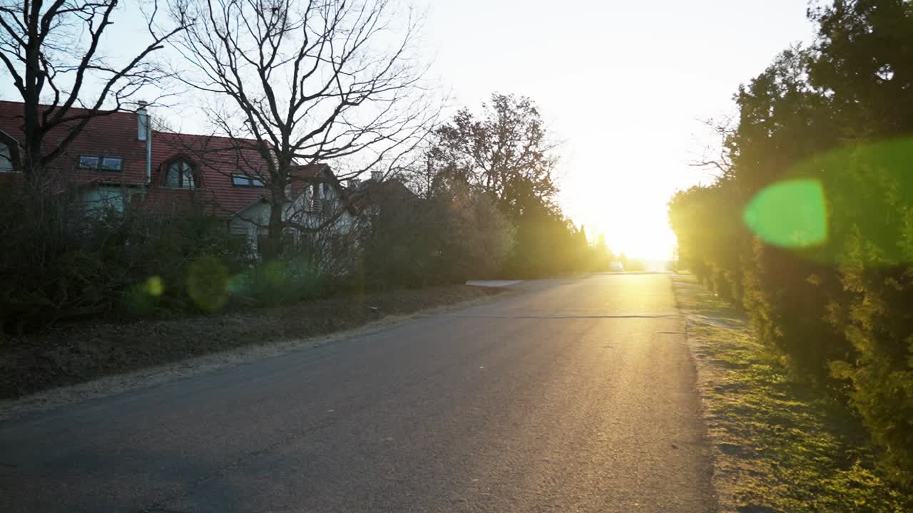 Road lined with houses at sunset