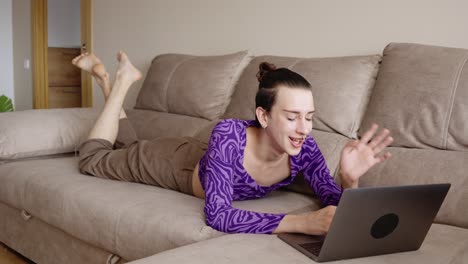 person using laptop on couch