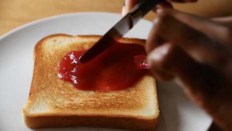 spreading jam on toast