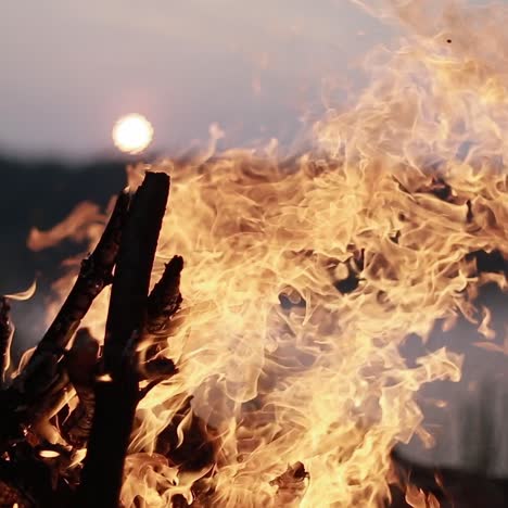 campfire burns brightly at sunset