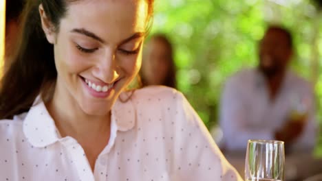 Woman-with-champagne-flute-in-restaurant