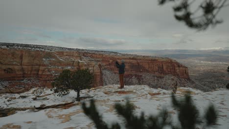 taking photos of the beautiful canyon covered in snowfall