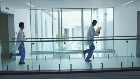 male and female doctors running in the corridor at hospital