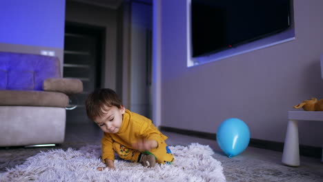 little cute toddler sits down on the floor. happy kid rolls on the soft fluffy plaid.