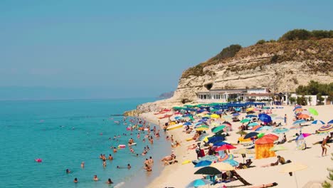 tourist - bathers - people on colorful beach - blurred persons - slow motion