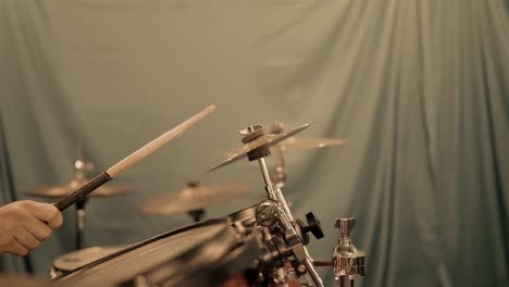 drummer hitting a cymbal on a drum kit